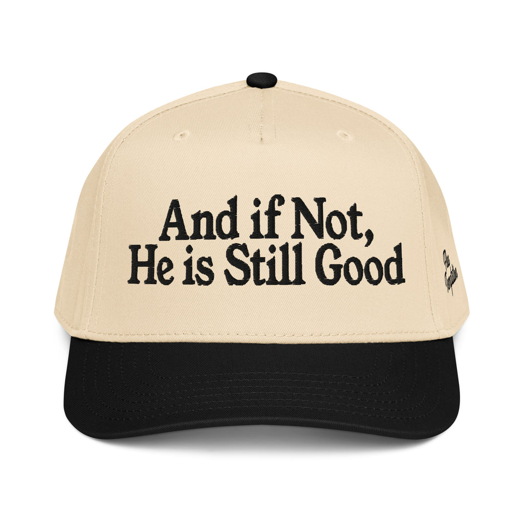 Beige cap with black text 'And if Not, He is Still Good' on a white background