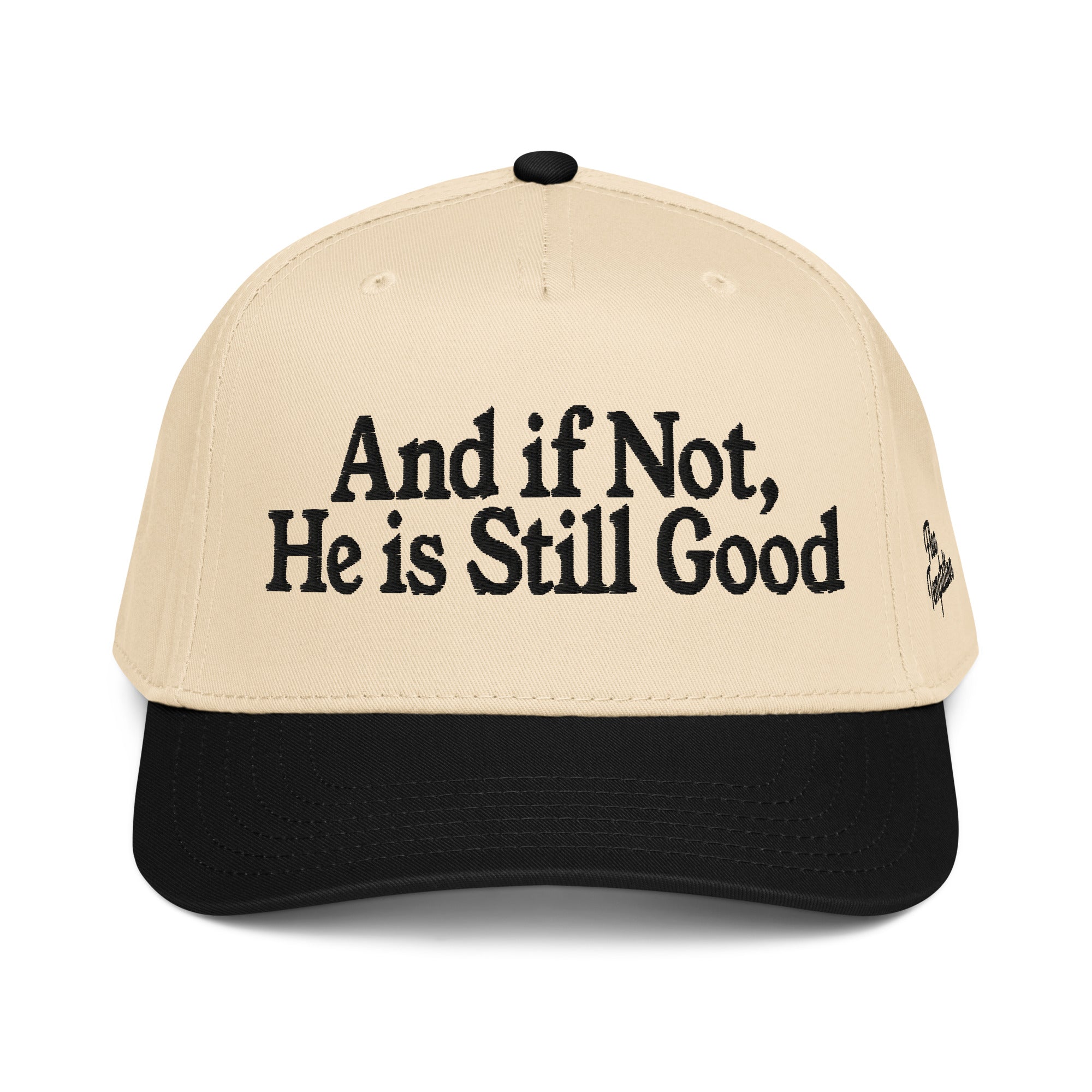Beige cap with black text 'And if Not, He is Still Good' on a white background