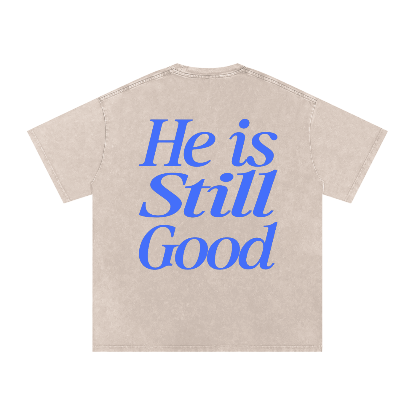 Beige t-shirt with blue text 'He is Still Good' on a white background